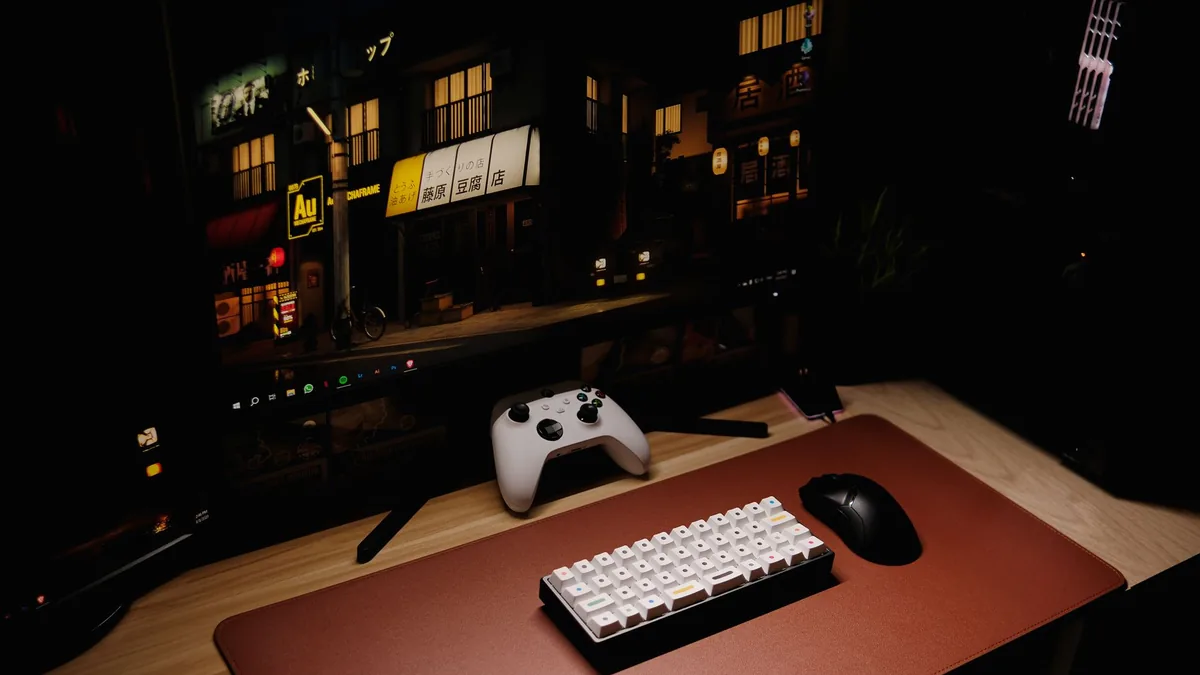 Close up of a gaming desk setup featuring a keyboard con