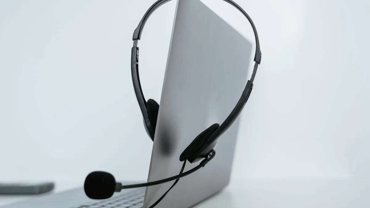 Close up of a laptop with a headset symbolizing remote w