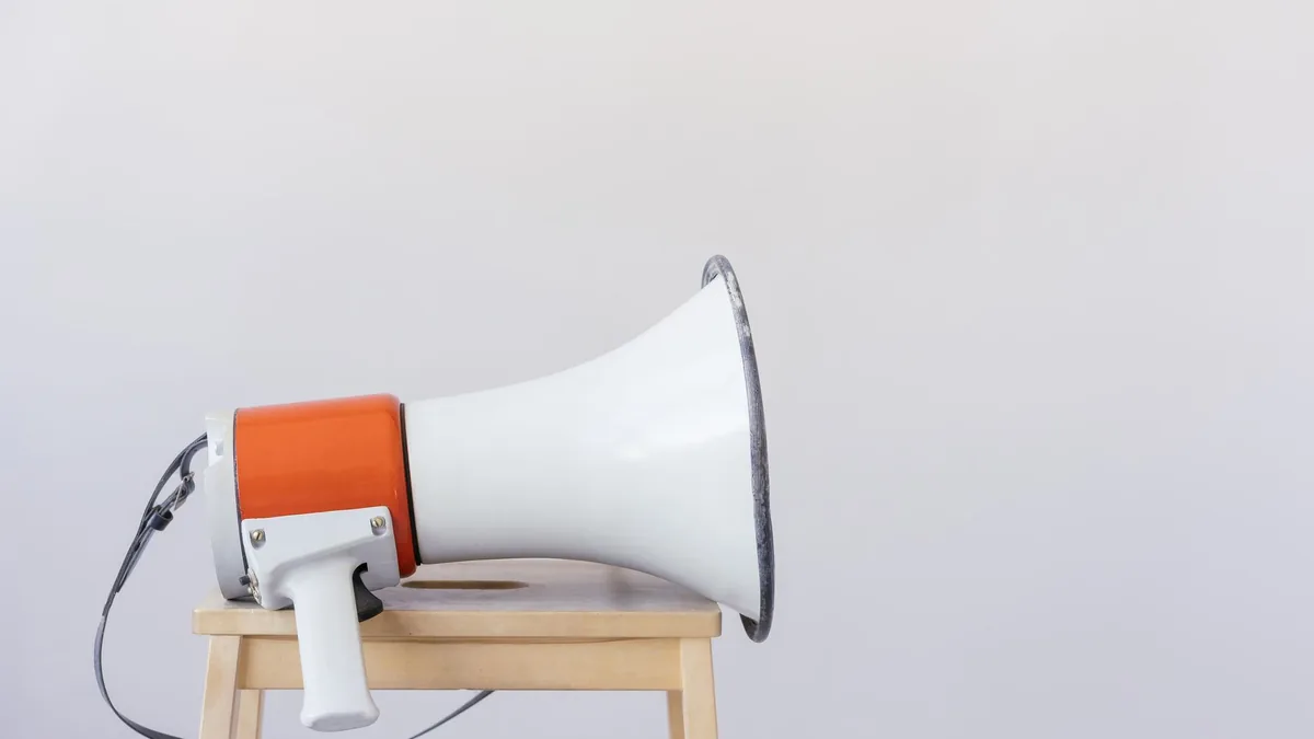 Close up of a megaphone resting on a wooden chair with a