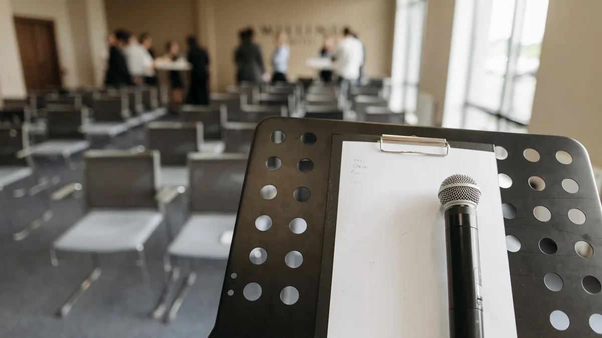 Close up of a microphone on a stand in a conference room