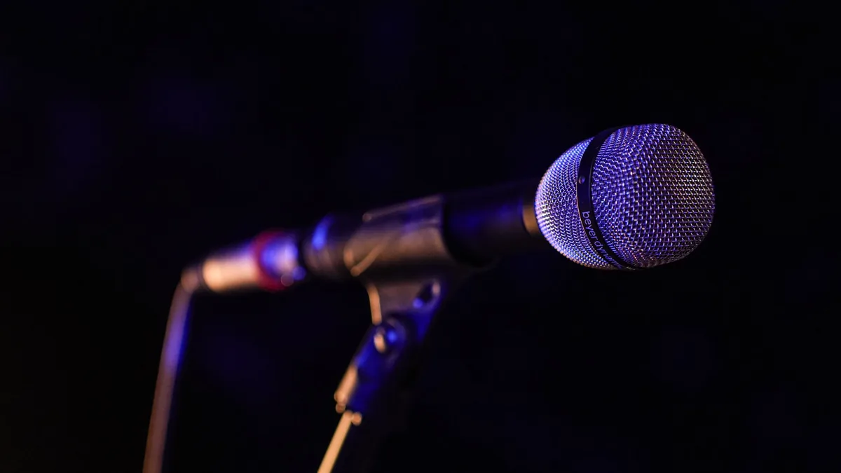 Close up of a microphone set up on stage highlighting co