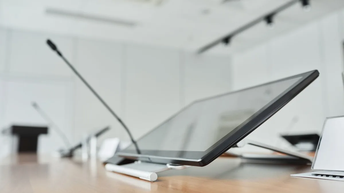 Close up of a modern conference room with a digital scre