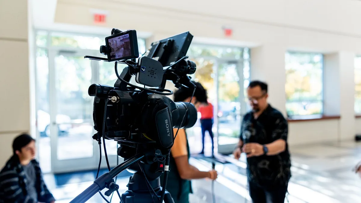 Close up of a professional video camera on a tripod with