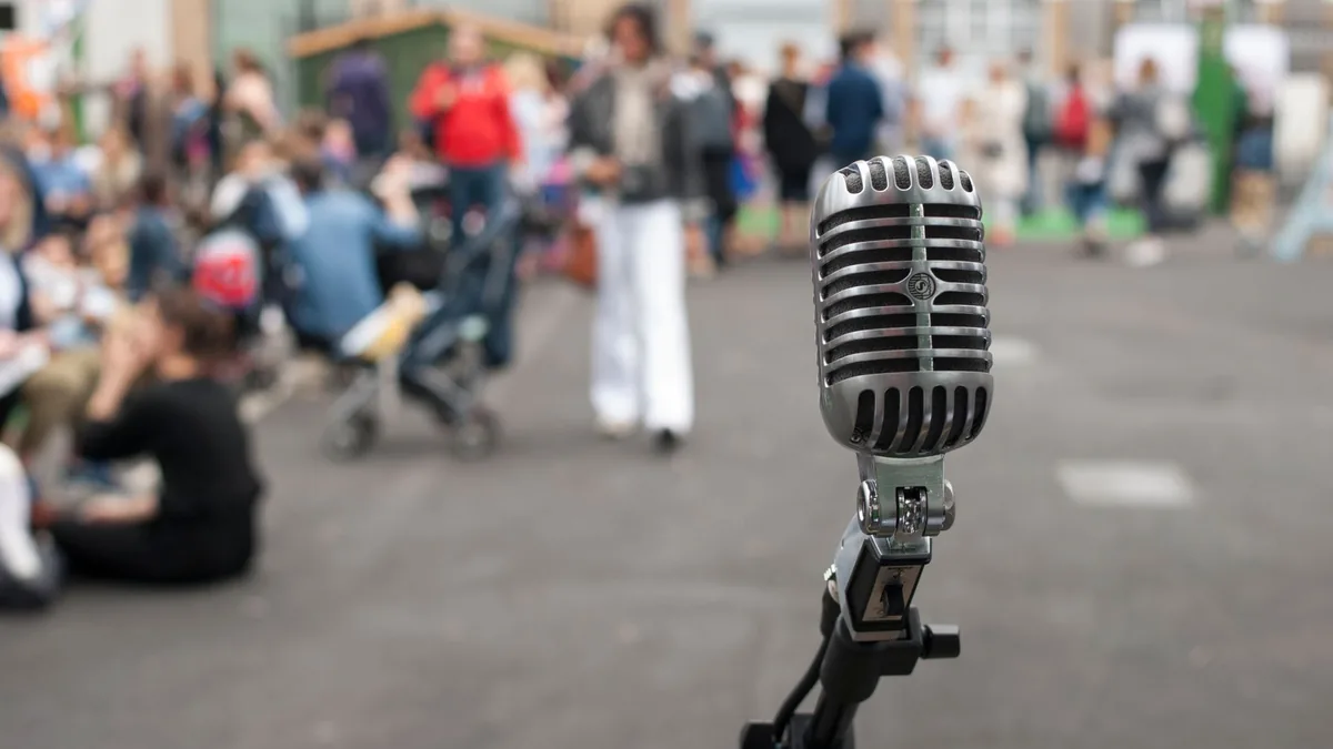 Close up of a vintage microphone with blurred crowd in t