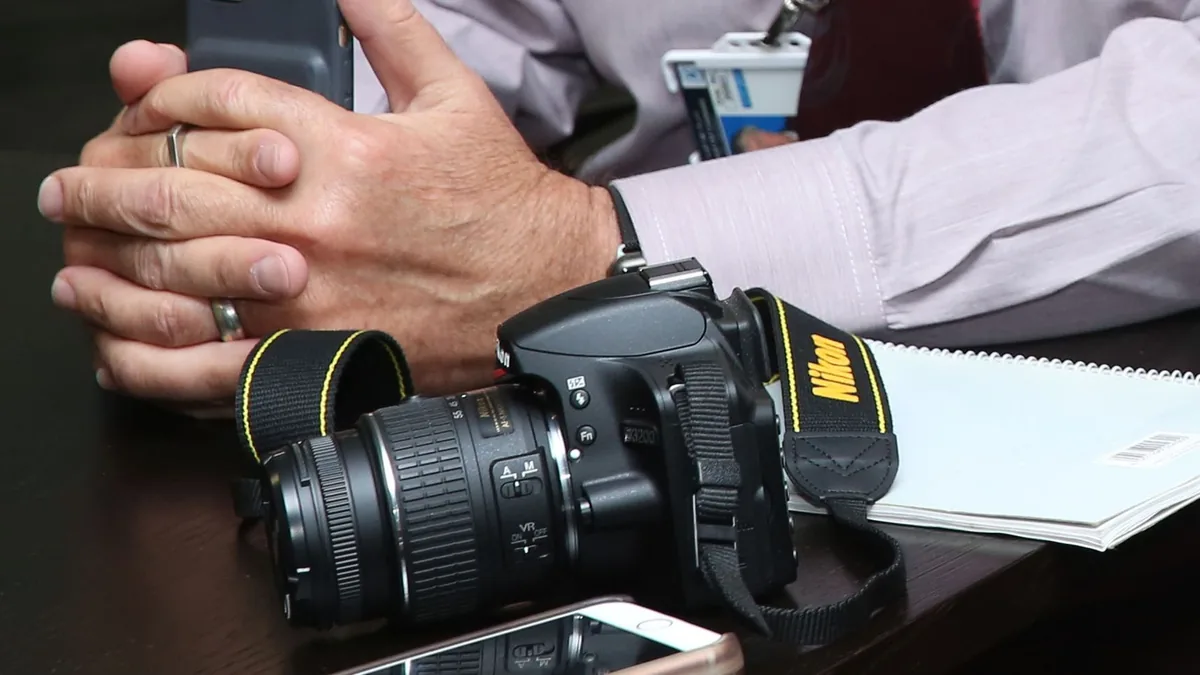Close up of a workspace featuring camera equipment smart