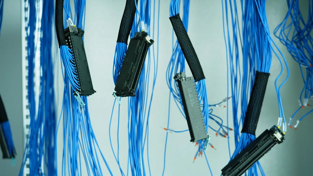 Close up of blue ethernet cables hanging in a data cente