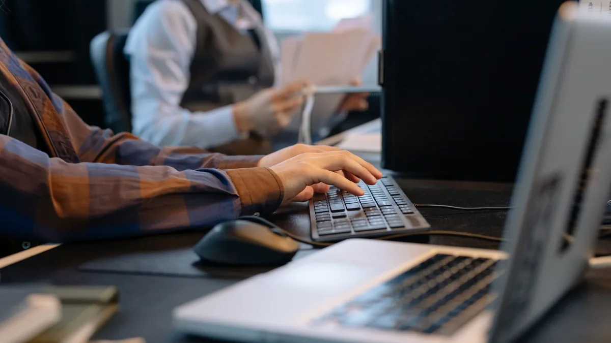 Close up of office workers engaged in a tech project at