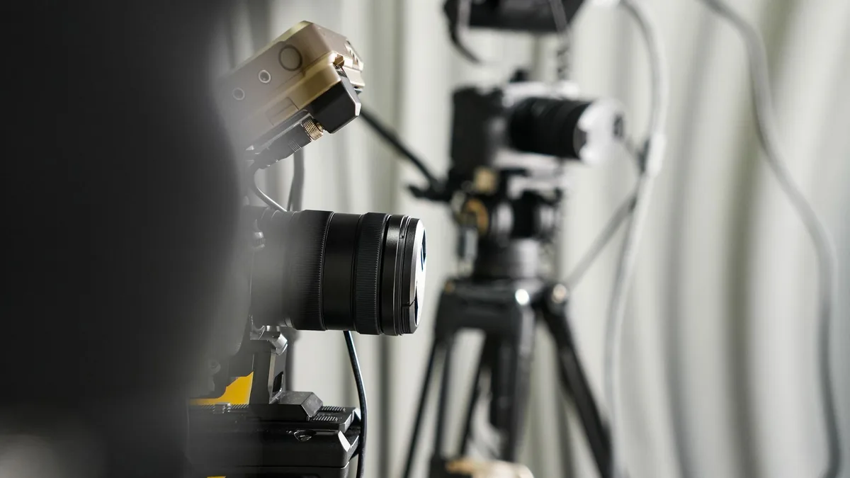 Close up of professional video cameras on tripods in a s