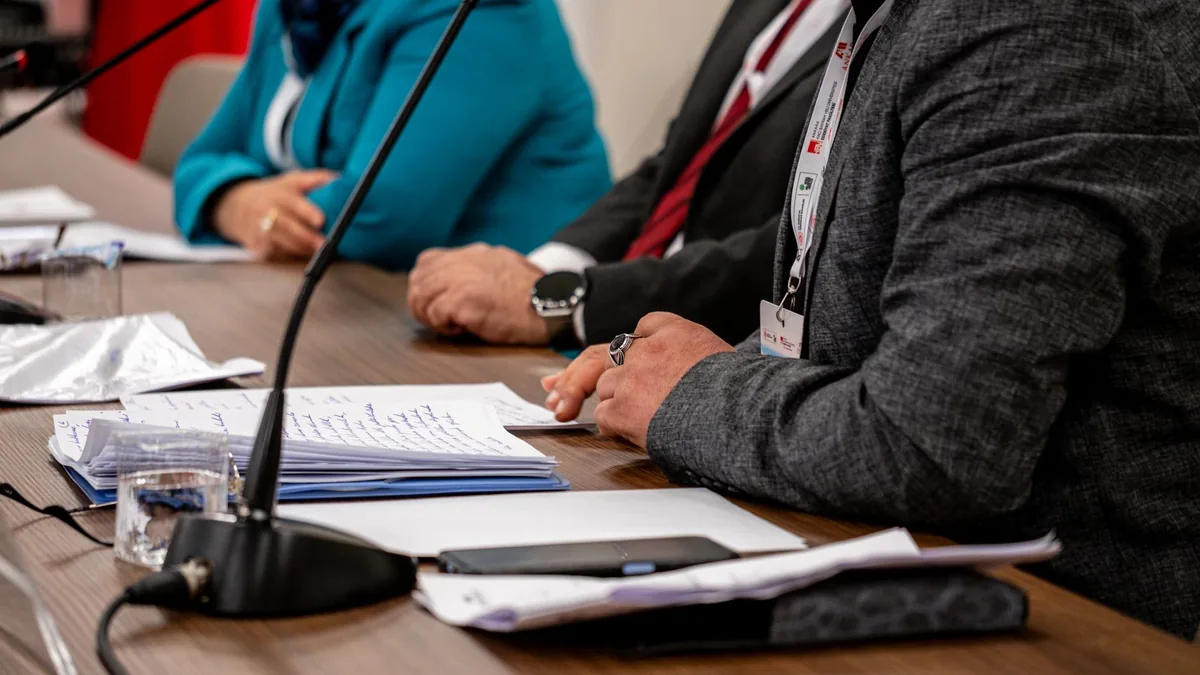 Close up of professionals discussing documents at a busi