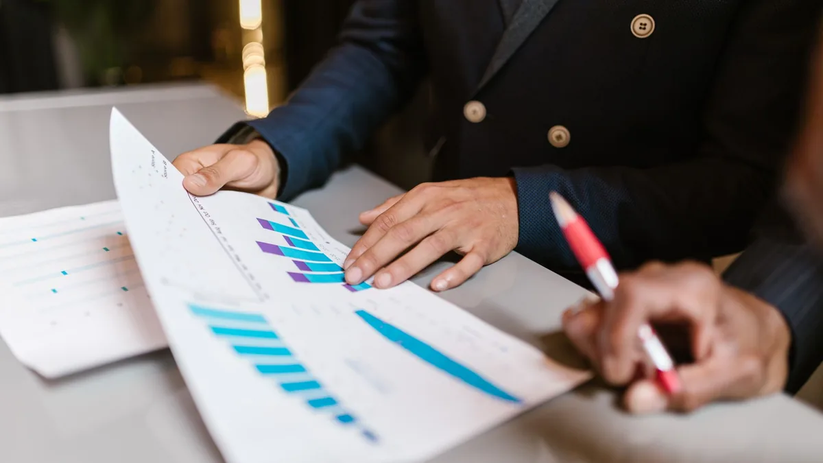 Close up of professionals reviewing financial graphs at