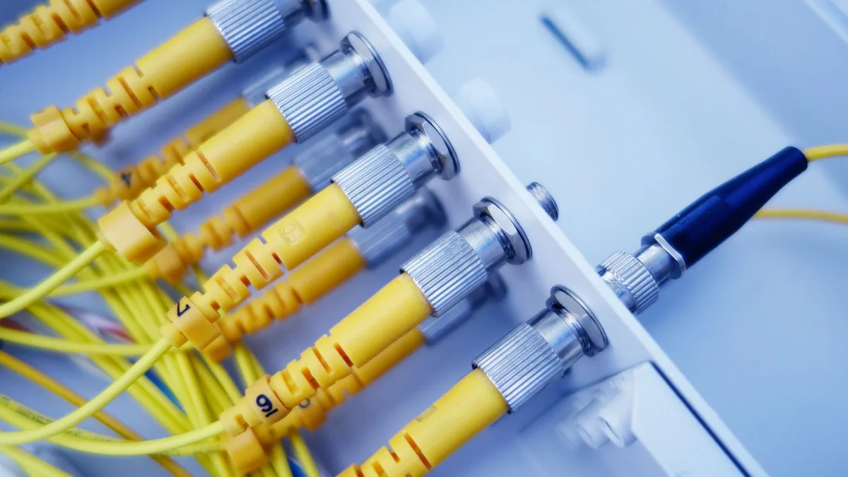 Close up of yellow fiber optic cables in a network serve