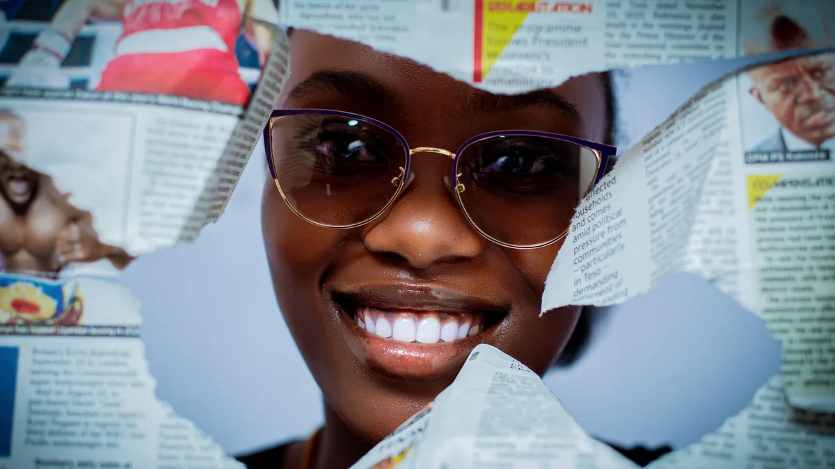 Close up portrait of a smiling woman with glasses framed