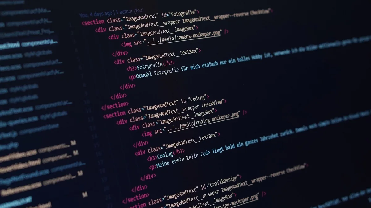 Close up view of html code displayed on a dark screen sh