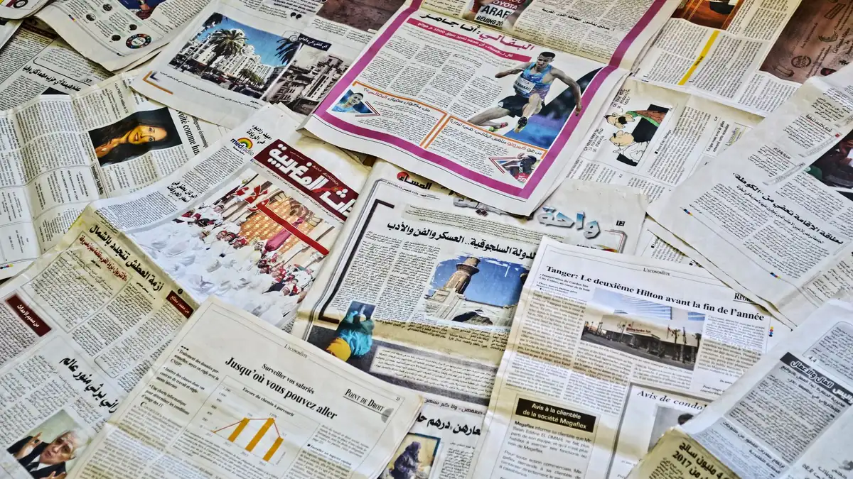 Close up view of various newspapers laid out showcasing