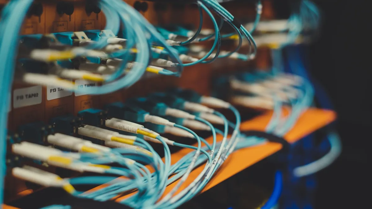 Closeup of many cables with blue wires plugged in modern
