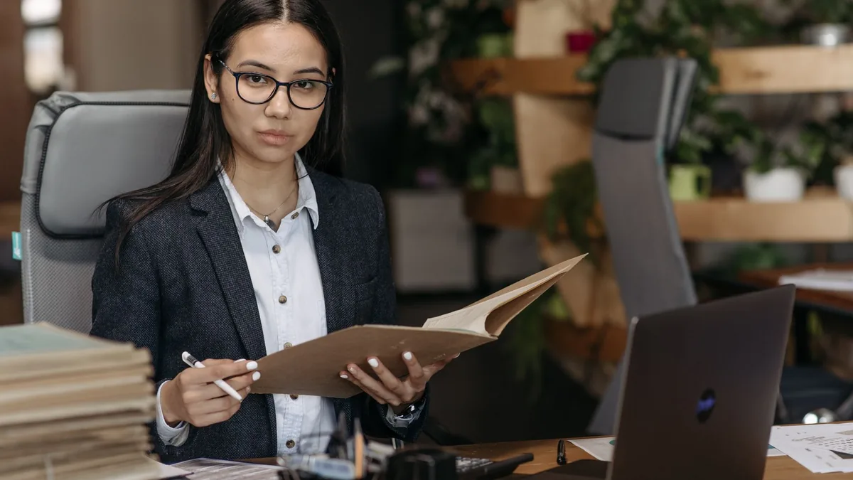 Confident businesswoman in professional attire reviewing