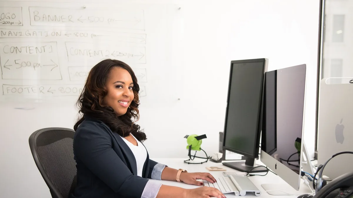 Confident businesswoman seated at her desk in an office