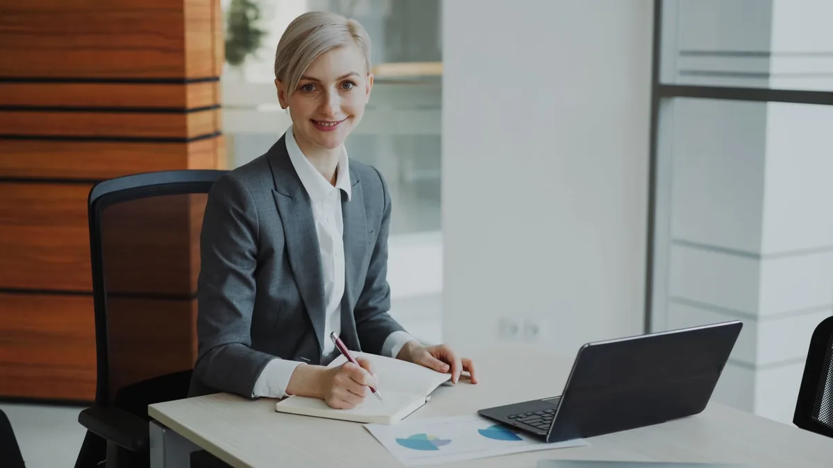 Confident businesswoman taking notes in a contemporary o