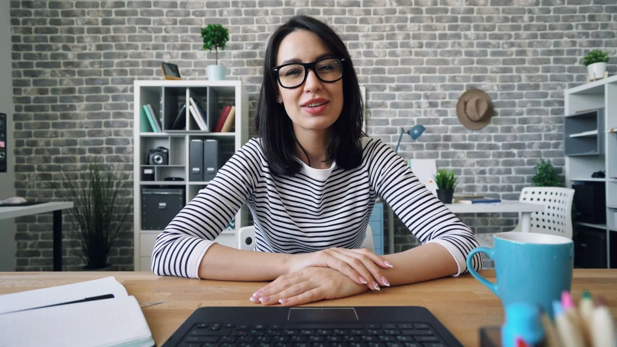 Confident businesswoman with eyeglasses working at a mod