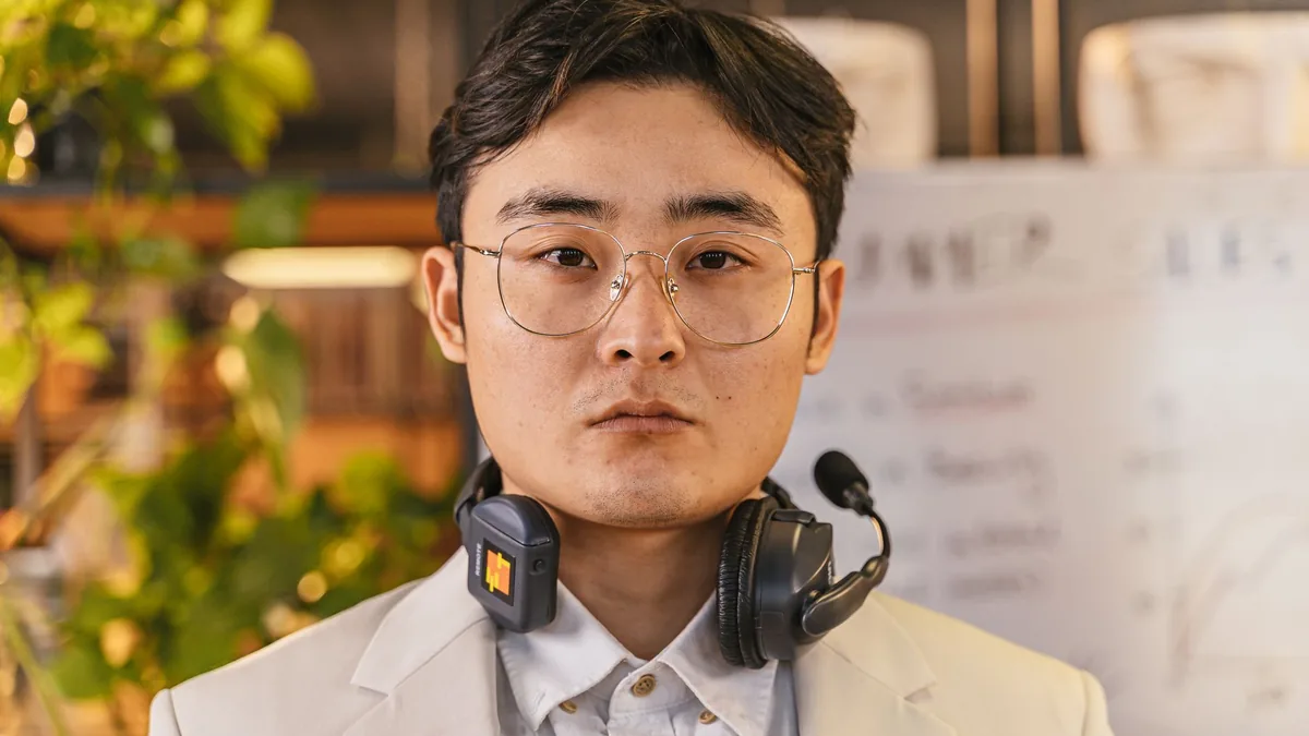 Confident man wearing headset eyeglasses and suit in a m
