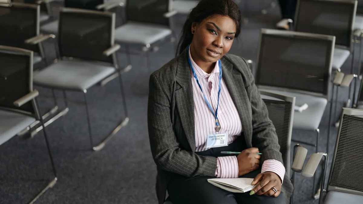 Confident woman in business attire sitting in a conferen