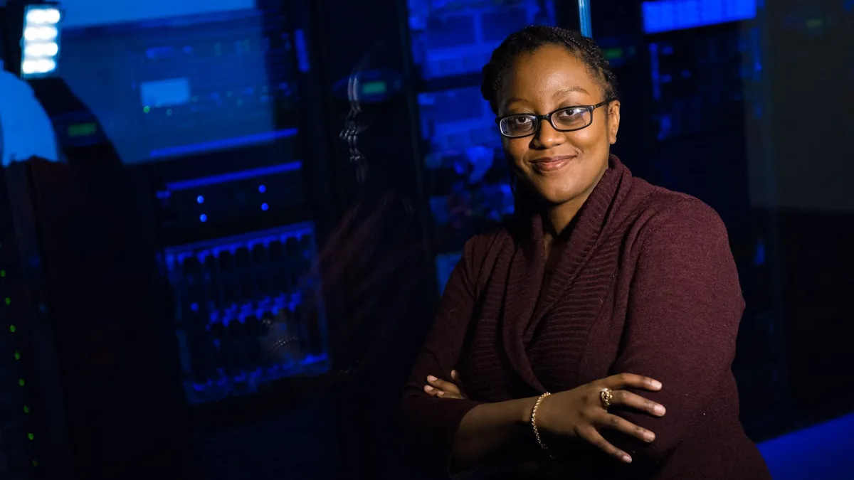 Confident woman in data center showcasing tech expertise