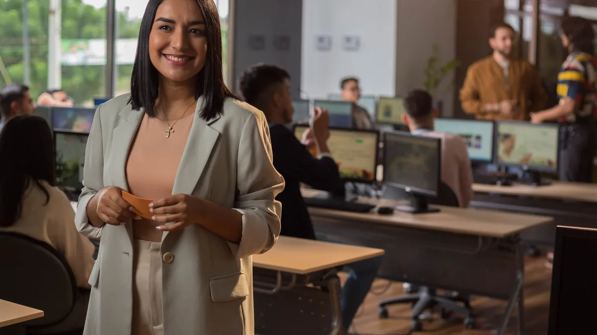 Confident woman smiling in a modern office setting with