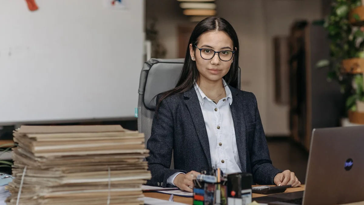 Confident woman with eyeglasses working in a modern offi