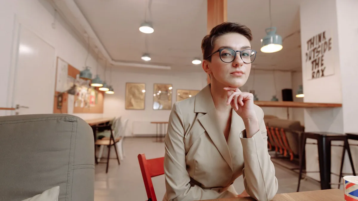Confident woman with short hair in modern office interio