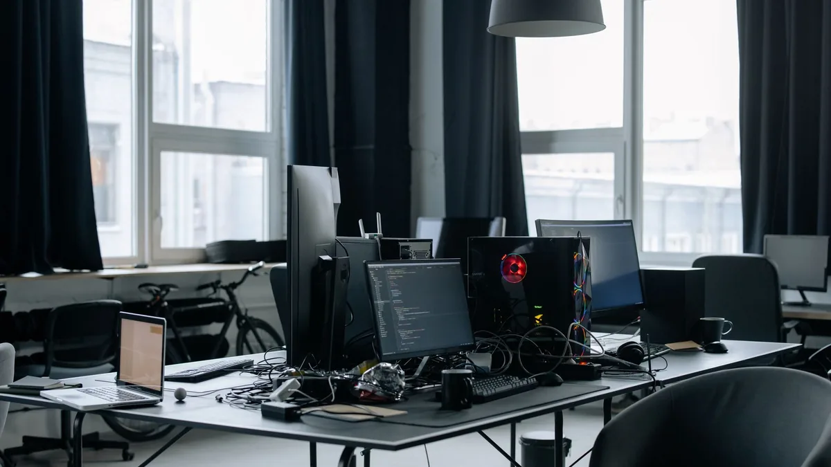 Contemporary workspace featuring computers coding screen