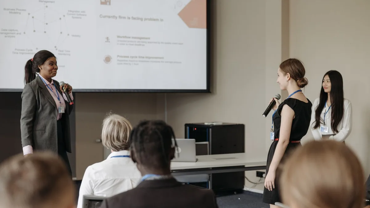 Corporate conference scene with women presenting and eng