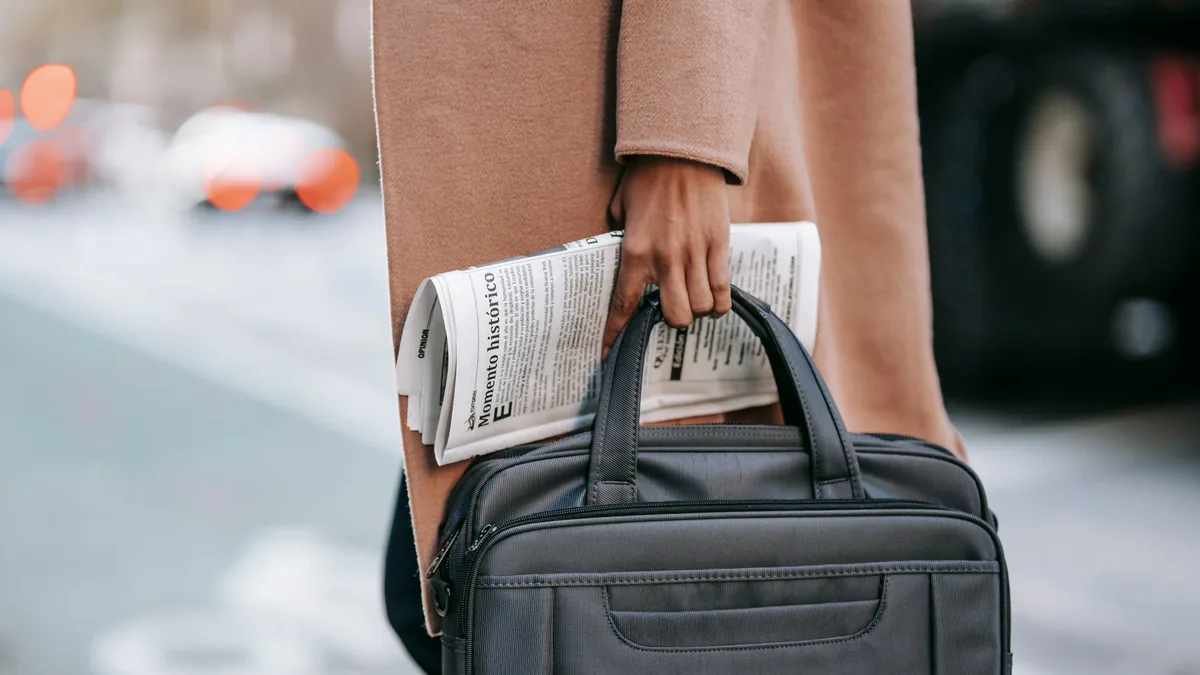Crop unrecognizable female entrepreneur in stylish brown