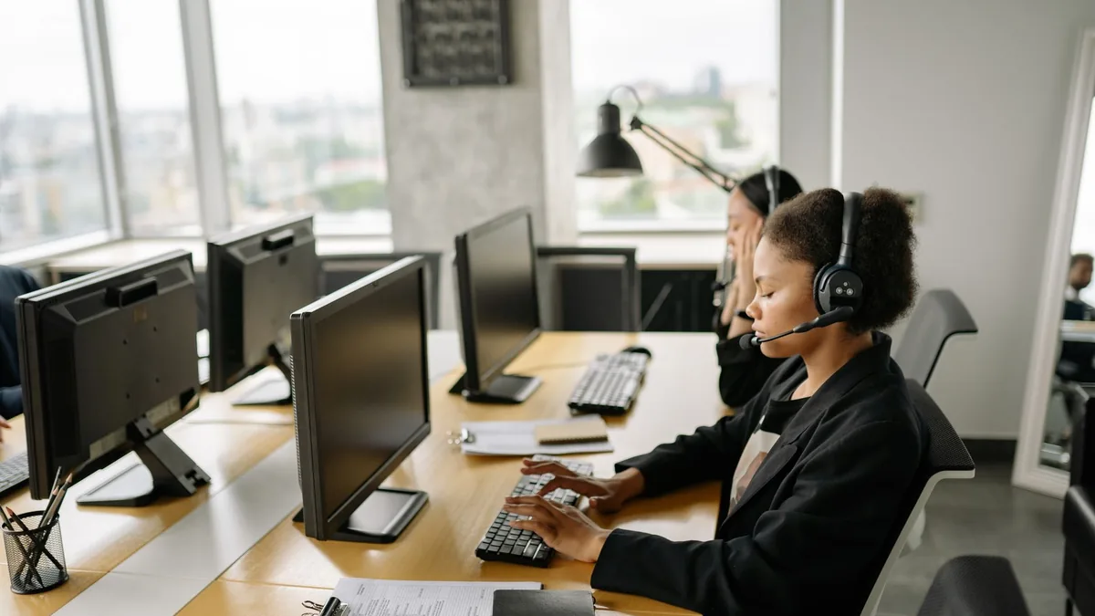 Customer support agents working at a call center with co