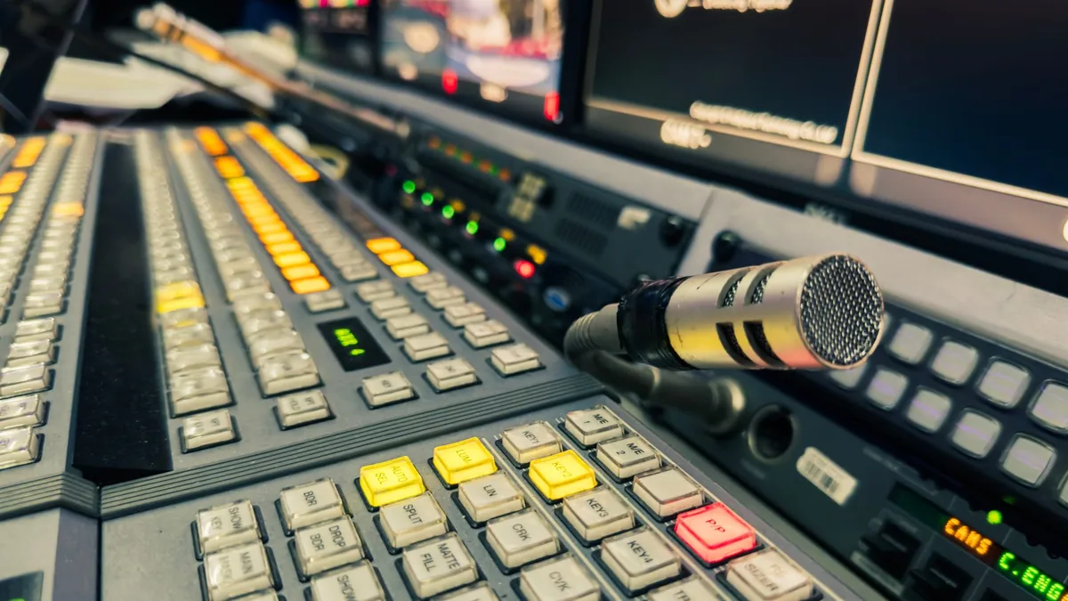 Detailed view of a broadcasting studio control panel wit