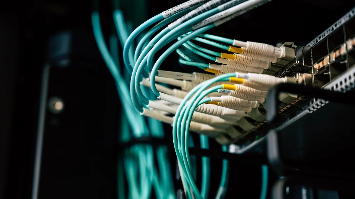 Detailed view of network cables plugged into a server ra