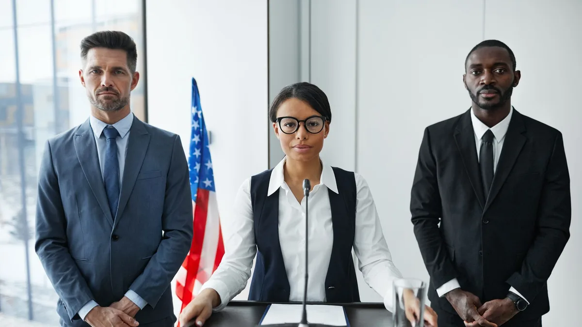 Diverse group of politicians in suits at a podium with a