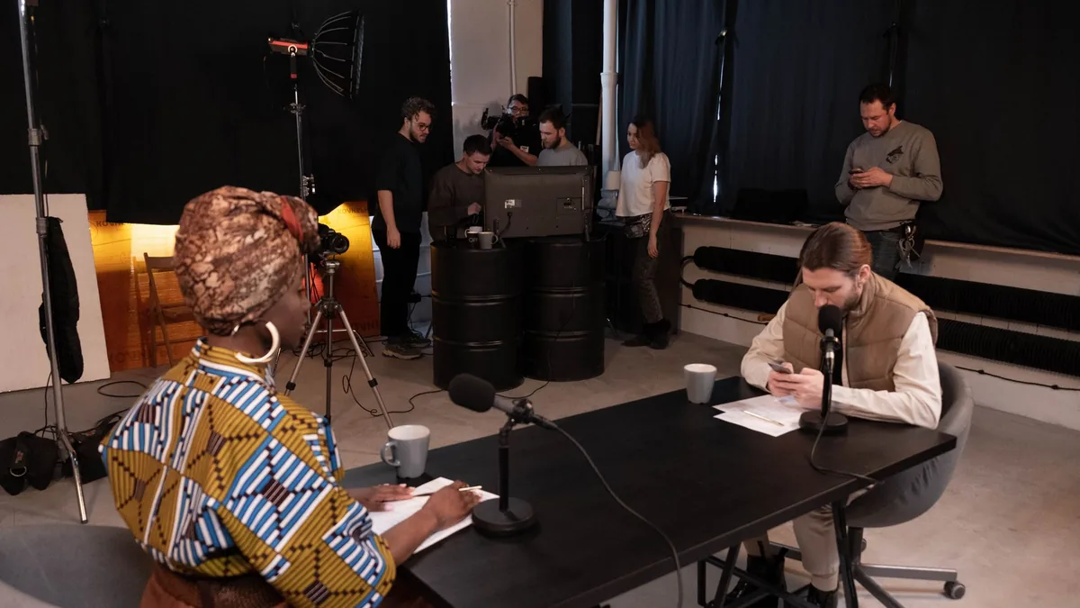 Diverse team in a studio setting recording a podcast wit