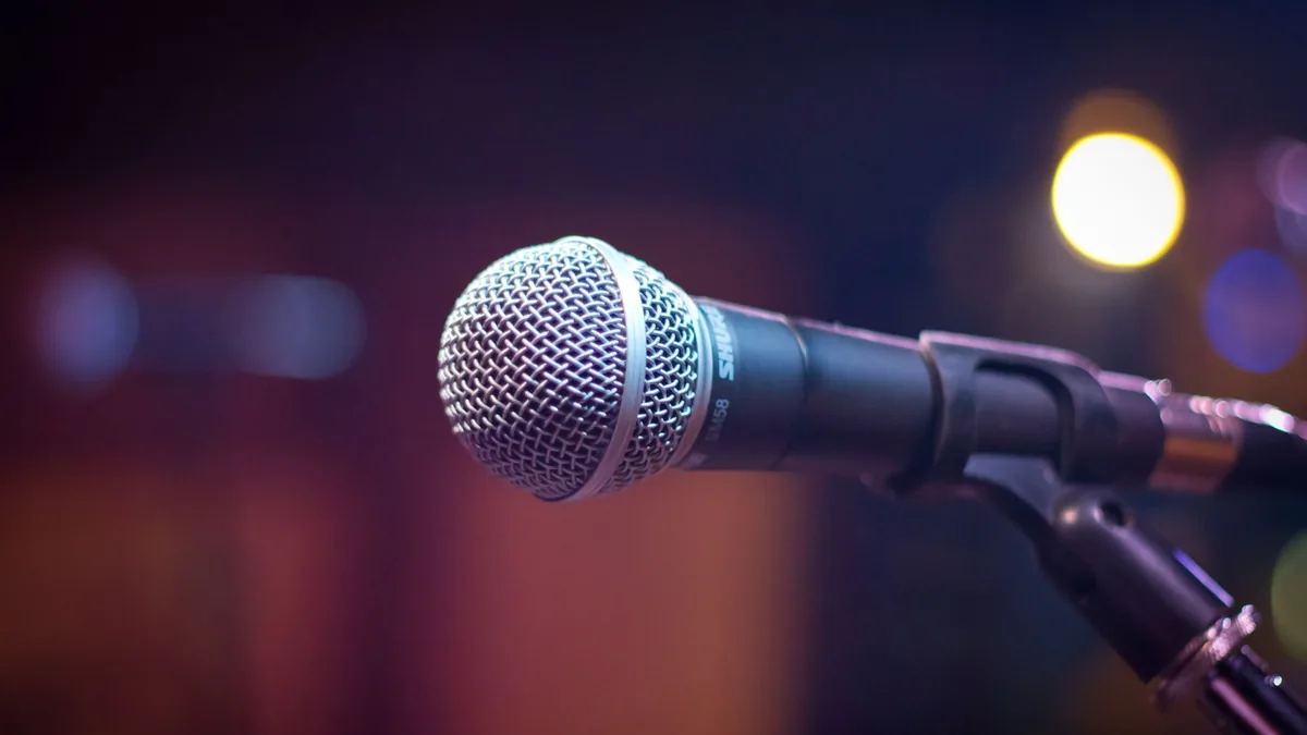 Dynamic microphone on stand with blurred stage lights in