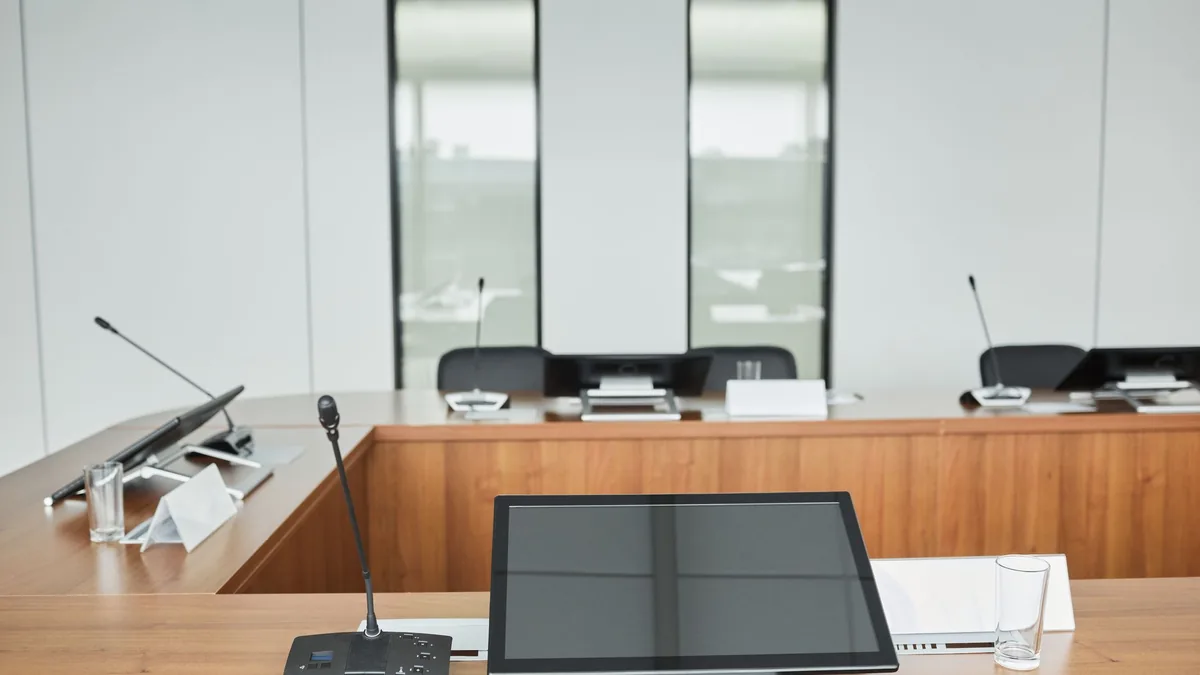 Empty conference room setup with microphones monitors an