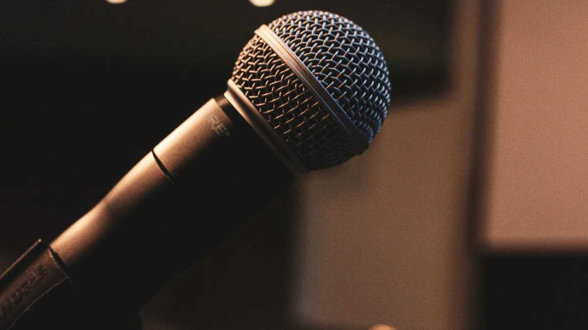 Extreme close up of a microphone in focus with a blurred