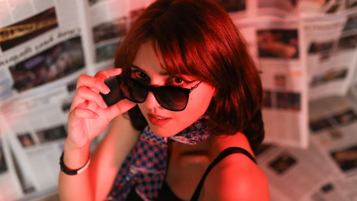 Fashionable woman wearing sunglasses with a vibrant red