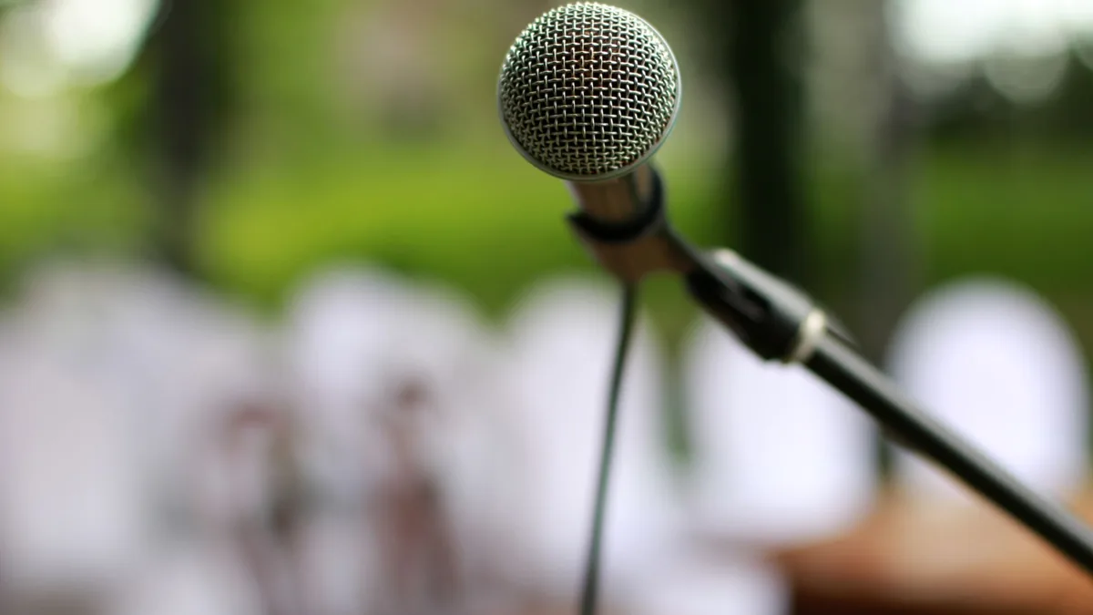 Focused view of a microphone on a stand outdoors ready f