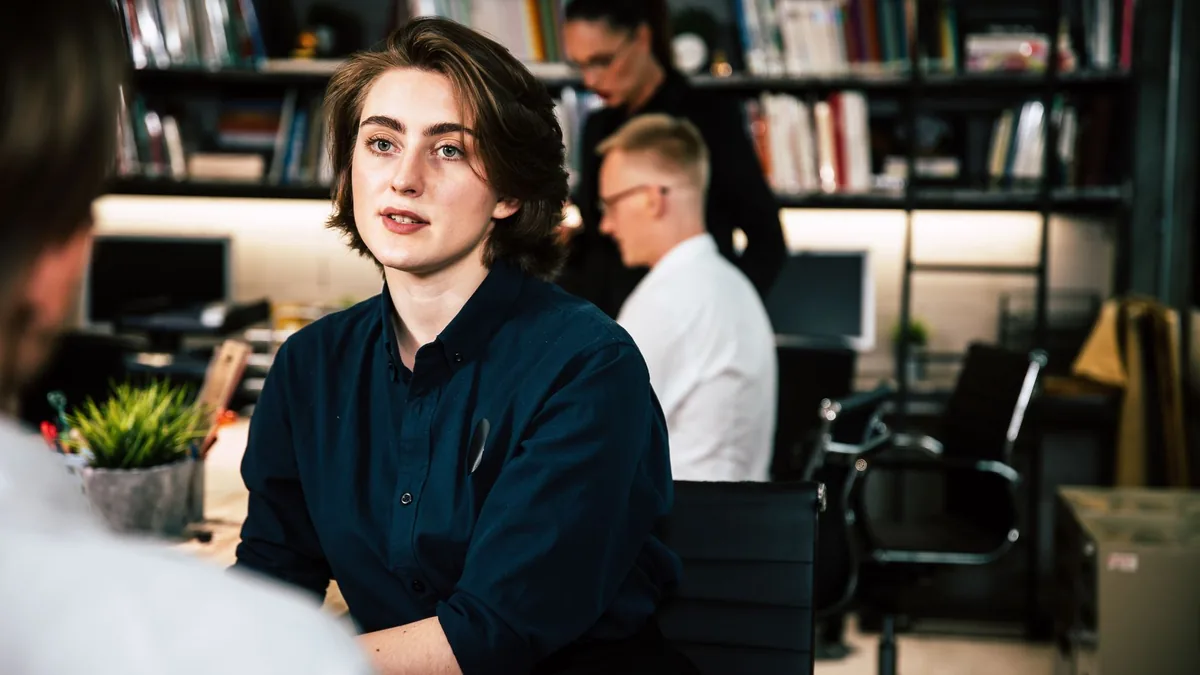 Focused young adult working in a modern office environme