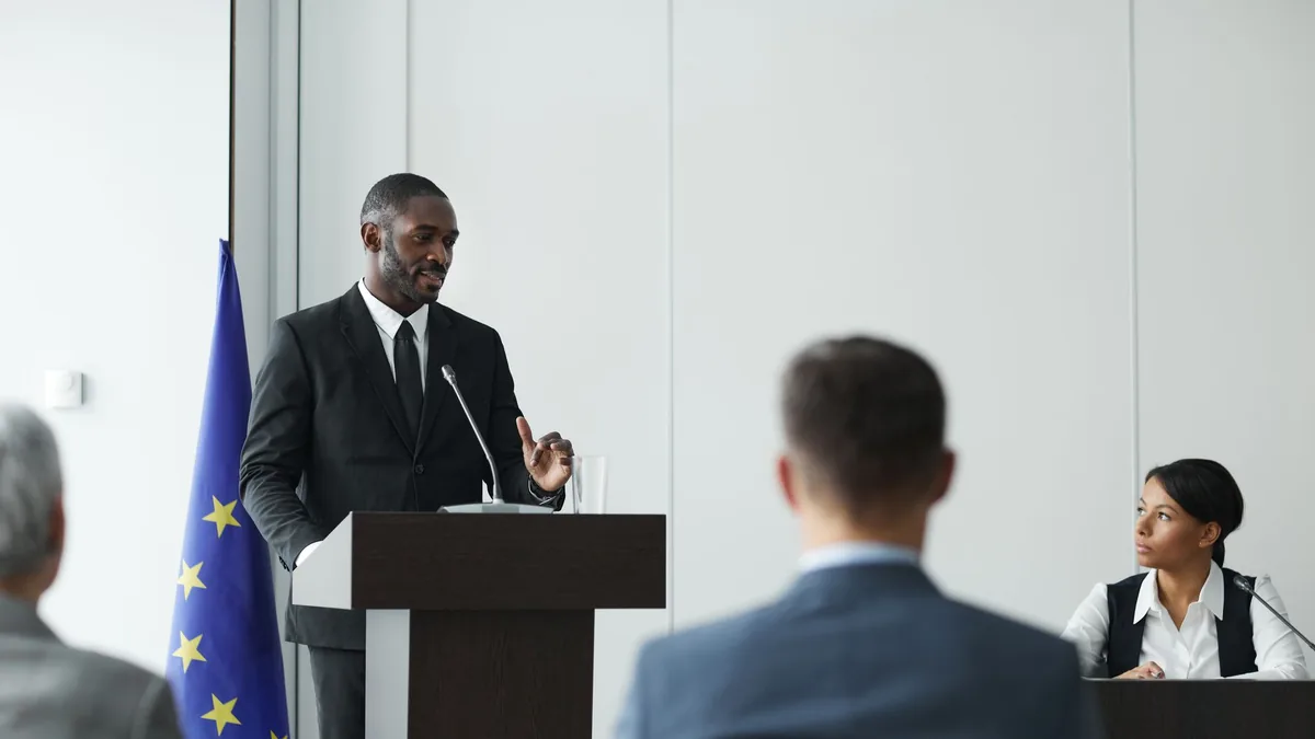 Formal business meeting with diverse speakers in a confe