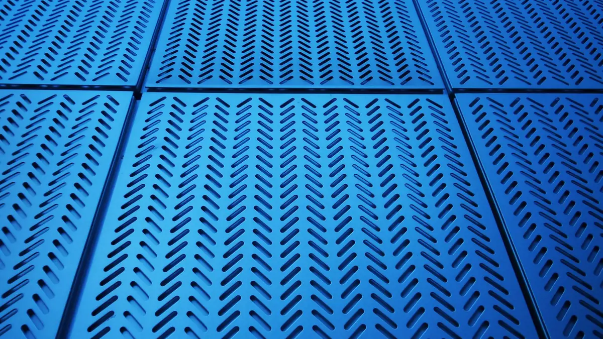 Geometric arrangement of blue metal panels with perforat
