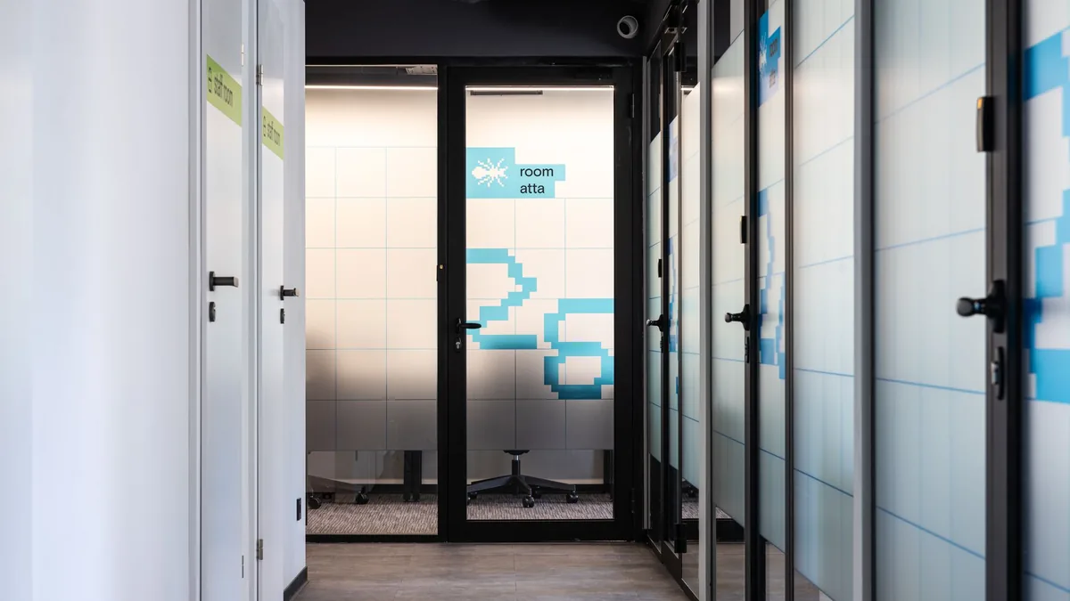 Hall with white and glass translucent walls and blue num