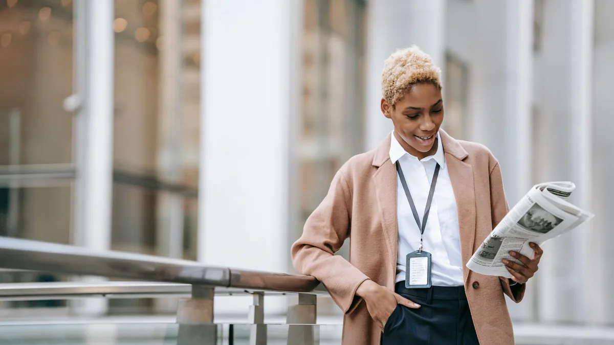 Happy young african american female entrepreneur with ba
