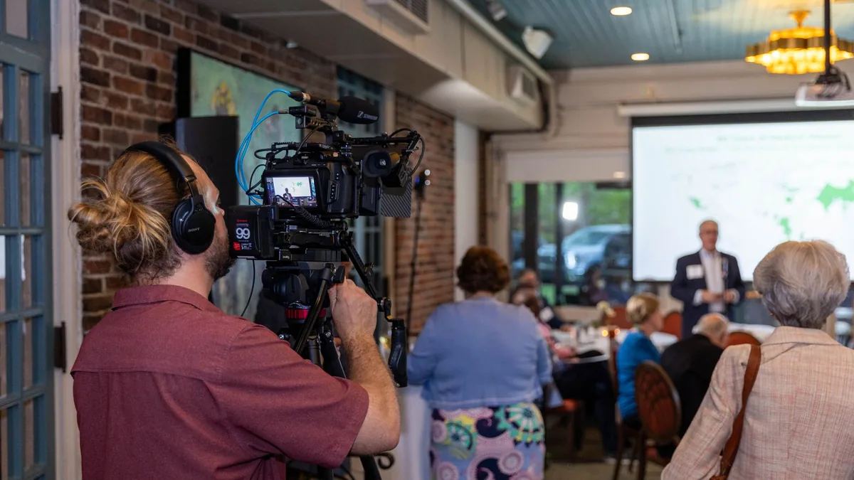 Indoor scene of a videographer documenting a professiona