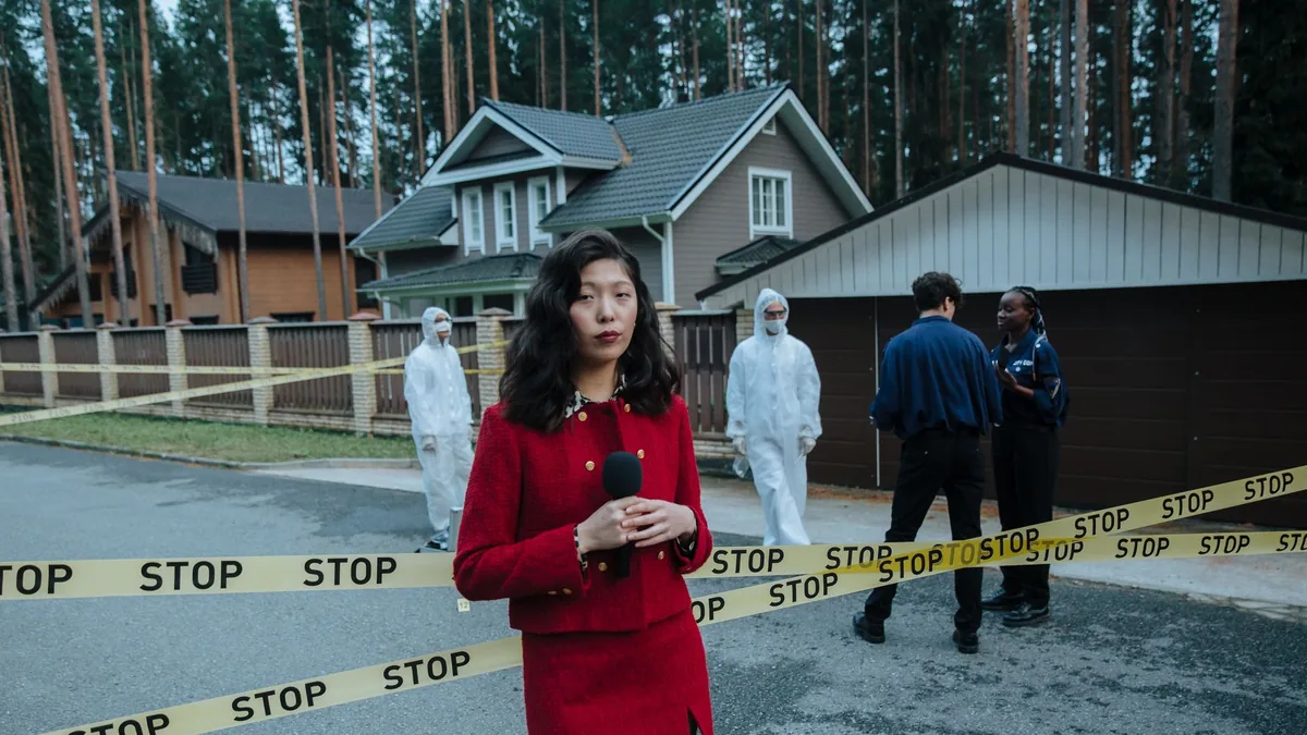 Journalist reporting from a crime scene with stop tape a