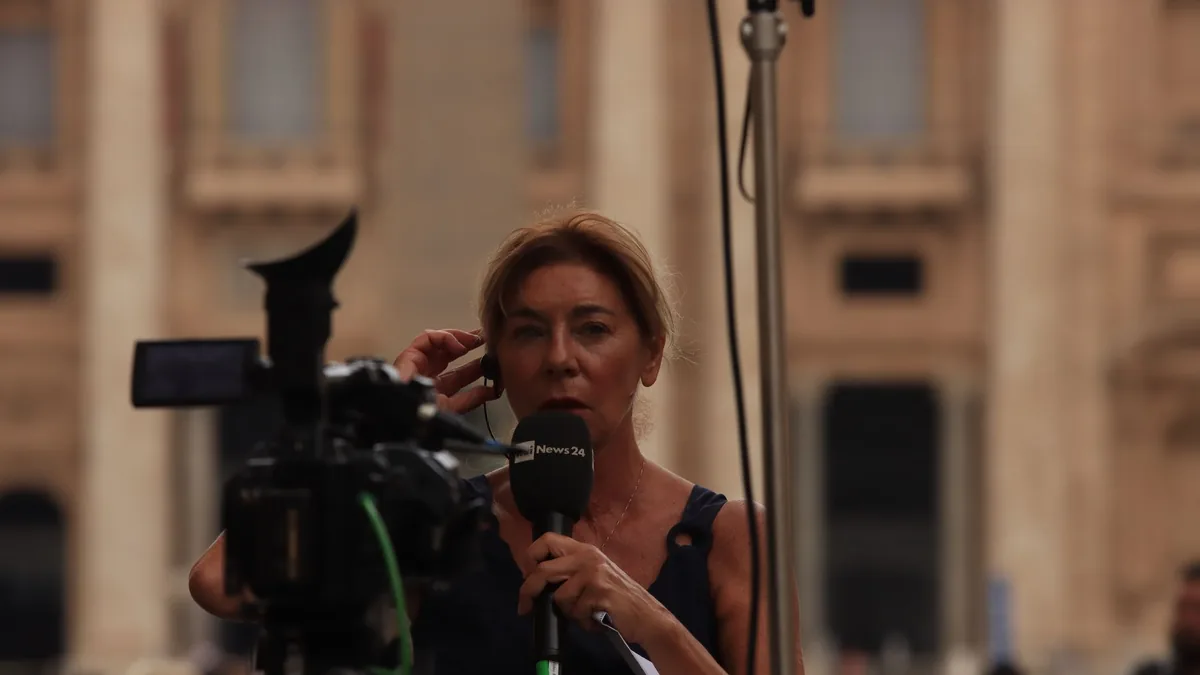 Journalist reporting live from vatican city capturing th